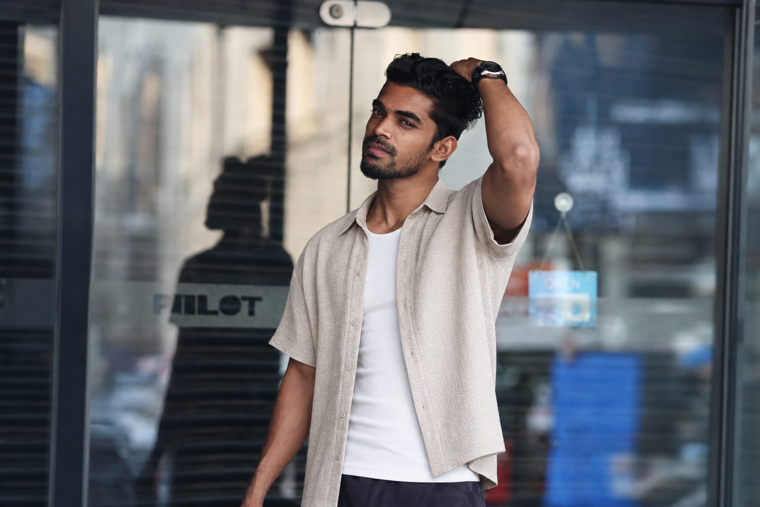 After: the same supplied real man model in the unchanged photo, wearing a beige boxy short-sleeve shirt over a white ribbed top